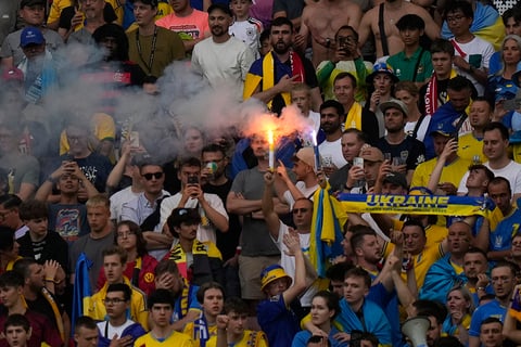 Ukrainian fans light a flare during Ukraine and Belgium match